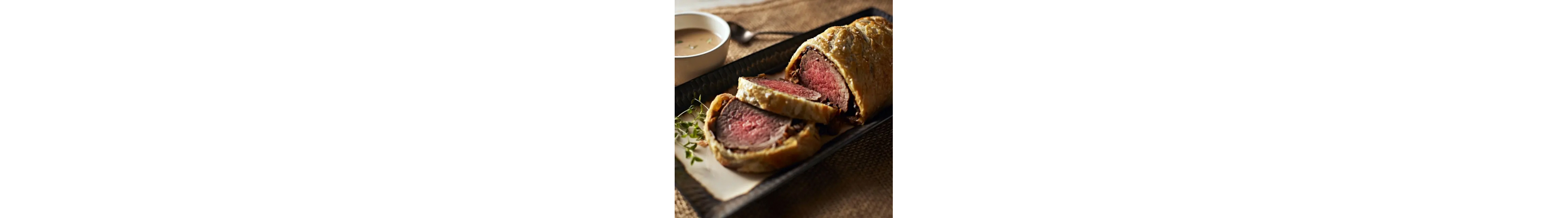 Beef wellington with a side of cognac sauce
